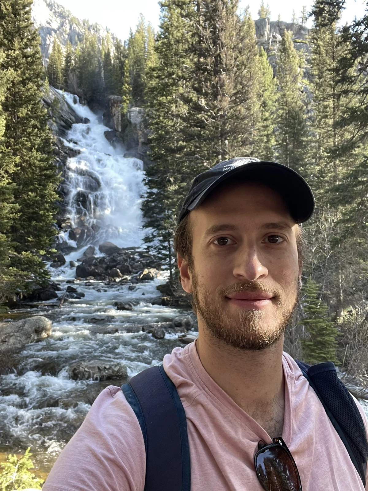 Daniel in front of a waterfall